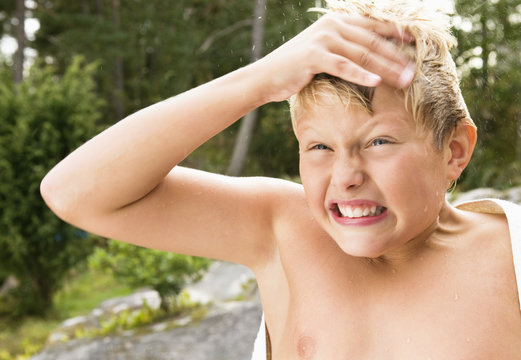Young boy grimacing