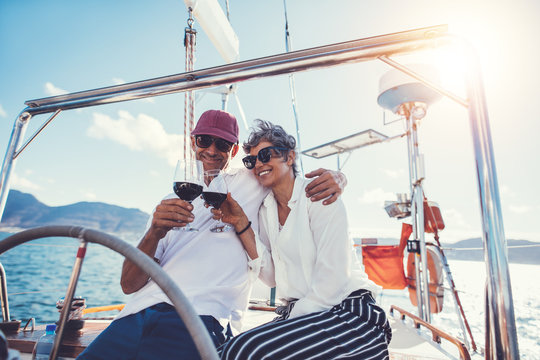 Senior couple enjoying wine on boat deck