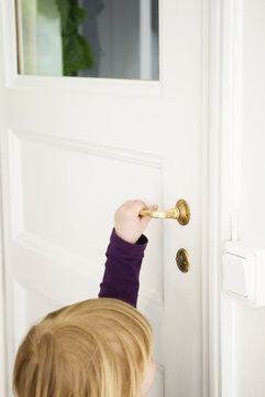 Little girl opening door
