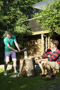 Friends slicing wood