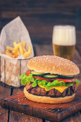 American Burger with bacon,cheese,tomato,lettuce and french fries 