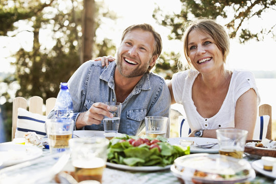 Happy couple having breakfast together outdoors