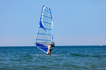 Windsurfer with windsurf on sea waves