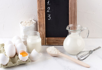 Fototapeta na wymiar Ingredients for baking - milk, eggs and flour wheat.