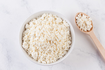 Fresh cottage cheese in a white bowl