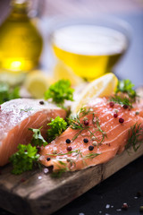 salmon steaks on wooden board marinated