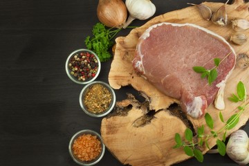 Raw meat pork steak on a cutting board. Preparing barbecue pork steak. Sales of pork on the grill. Advertising on butcher. Raw pork butcher.
