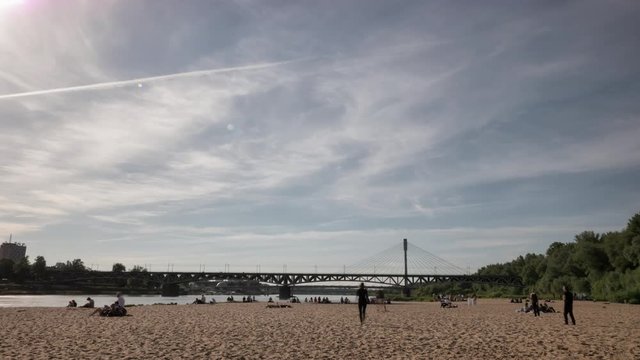 People resting on city beach in Warsaw. Time lapse footage in UHD.