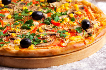 Pizza with olives, tomatoes and mushrooms isolated on white