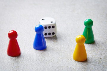 Colored board game pieces on stone table