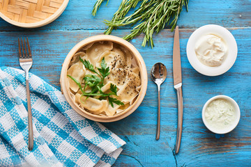 Top view of healthy Breakfast with homemade dumplings with sour cream on rustic wooden table
