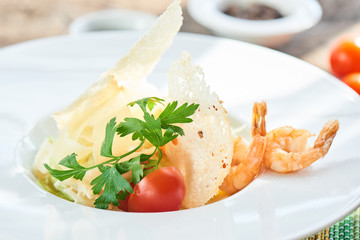 Caesar salad with shrimp served on a white plate