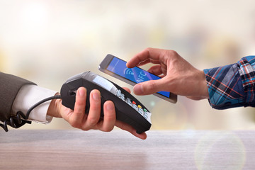 Customer paying a merchant with mobile phone nfc technology