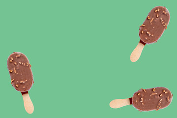 three ice creams on green background