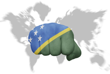 fist with the national flag of Solomon Islands on a world map background