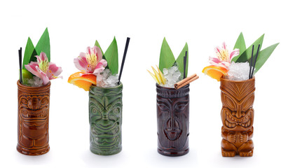 Tropical cocktails served in a tiki style glass and garnished with fruits - obrazy, fototapety, plakaty