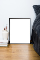 Fototapeta premium Empty blank classic black frame on a floor, minimal home bedroom
