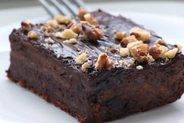 Delicious chocolate brownie. Close up of chocolate brownies. Delicious homemade chocolate cakes on top with walnuts. Shallow depth of field.