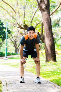 Asian Man Take Breathless Break Of Running