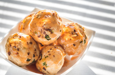Chicken meatballs under sweet chili pepper sauce