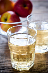 Two glasses of cider on the wooden background