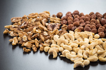 Almonds, cashew, walnuts and hazelnuts on black background