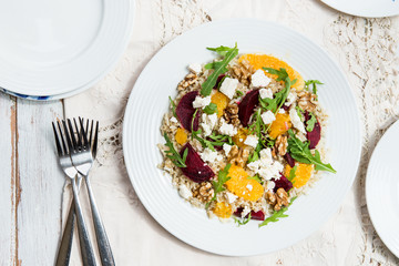 Warm Healthy quinoa, brown rice, cooked beetroot and orange sala