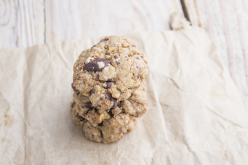 Chocolate cookies on white linen napkin on wooden table