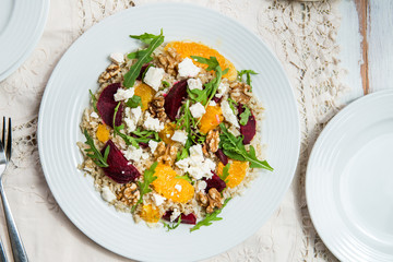 Warm Healthy quinoa, brown rice, cooked beetroot and orange sala