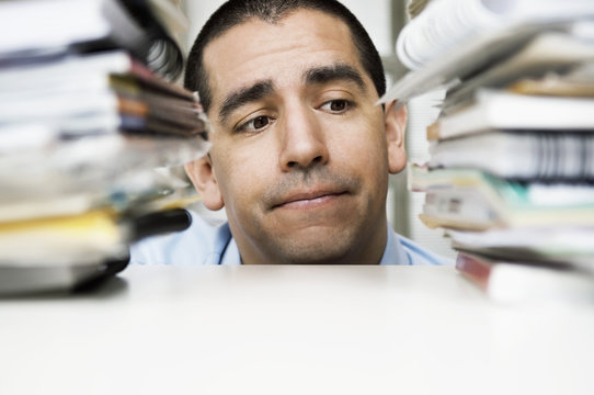 Man between pile of books