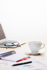 Office workplace with with laptop and coffee