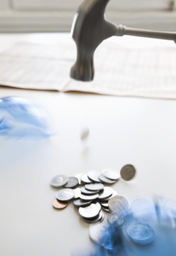 Hammer hitting coins