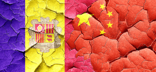 Andorra flag with China flag on a grunge cracked wall