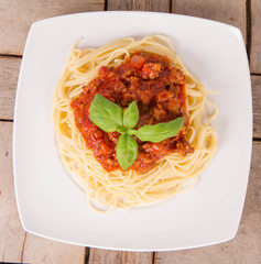 Spaghetti bolognese on a plate on a wooden background