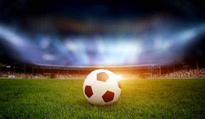 Soccer ball on the field of stadium - obrazy, fototapety, plakaty