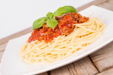 Spaghetti bolognese on a plate on a wooden background