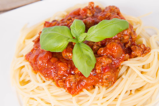 Spaghetti bolognese on a plate on a wooden background