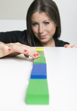 Woman putting five blocks in a row