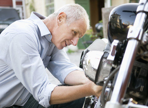 Man tinker with his motorbike