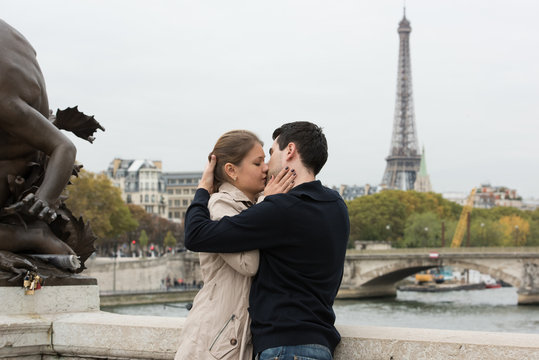 young couple in Paris kissing