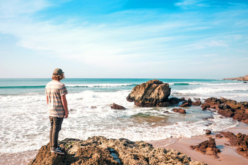 Young man looking for waves 