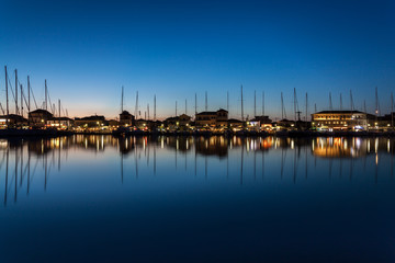 A calm night in Lefkas, Greece. Yachts docked in the city marina.