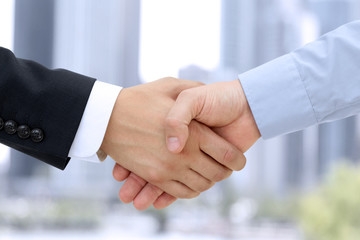 Close-up image of a firm handshake  between two colleagues outsi