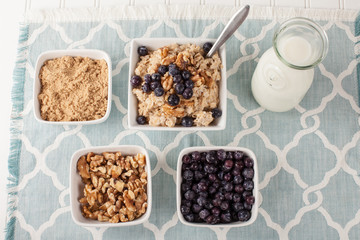 Oatmeal with chia seeds, brown sugar, blueberries, walnuts, and milk