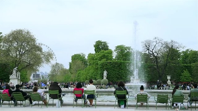 People sitting around fountain in Jardin des Tuileries in Paris