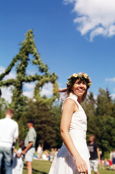 Girl with garland dancing around midsummer pole