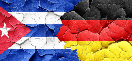 Cuba flag with Germany flag on a grunge cracked wall