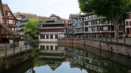 Summer day in Strasbourg. Medieval cityscape of Rhineland black and white timber-framed buildings in the Petite-France district alongside the river Ill on sunny day - France, Alsace region.