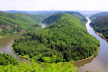 Saarschleife - The Saar river turning around the hill in Mettlach, Saarland, Germany. View of the Saar river bend from the vantage point Cloef. Beautiful trip destination on summer day.