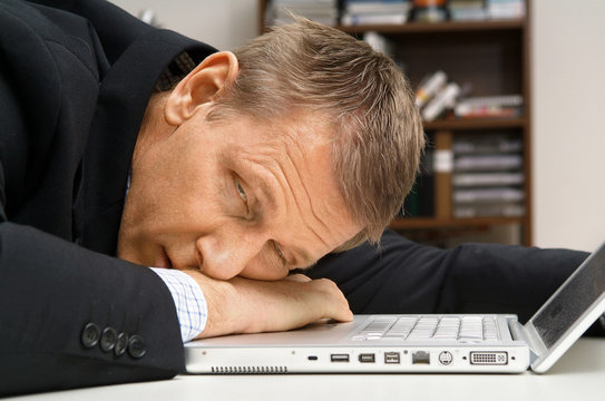 Man has dozed off by computer